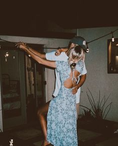 a man and woman dancing outside at night