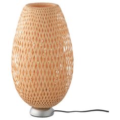 a wooden table lamp with a cord attached to it