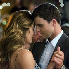 a man and woman are dancing together at an event