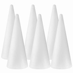 five white cones are lined up in a row on a white background, with one cone facing the camera