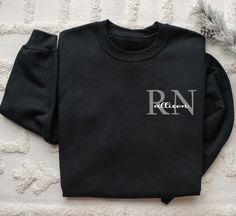 Personalized Nurse Sweater. Custom Crewneck Sweatshirt with any names added to it.  Start with the initials ex: RN, NP, LPN and then add your name across it. Printed on chest of shirt for minimalist design style. Classic yet beautiful. Great gift idea for birthdays, mothers day, or Christmas.  This sweatshirt is a super soft combination of cotton and polyester and will keep you warm all winter, and with our super soft dtf durable image this item will last many winters to come. This item is custom made to order in our home shop just for you as soon as your order is placed. --> OUR SWEATERS AND MATERIALS <-- 8 oz., 50% cotton, 50% polyester Heather Sport colors: 60% polyester, 40% cotton 1x1 ribbed collar, cuffs and waistband with spandex Double-needle stitching throughout Pill-resistant air Nurse Sweatshirt Ideas, Cricut Clothes, Nurse Sweater, Minimalist Design Style, Custom Crewneck Sweatshirts, Custom Crewneck, Merch Design, Niagara Falls Ny, Nurse Sweatshirt