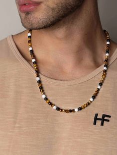 6mm Brown Tiger Eye, Howlite, and Black Onyx Nialaya Logo Bead in Stainless Steel with Gold Plating Lobster Clasp in Stainless Steel with Gold Plating Handmade in Los Angeles Model is wearing 24 Inch Necklace Product Code: MNEC_228 Designer's Notes Create a classic look from this warm brown tiger eye necklace with crisp white accents. Strung by hand in our Los Angeles studio, this piece is a must-have! Please note that all our pieces are crafted by hand and one-of-a-kind, and may therefore vary Los Angeles, Angeles, Masculine Jewelry, Tiger Eye Necklace, Black Beaded Necklace, Brown Tiger, Brown Tiger Eye, Tigers Eye Necklace, Black Bead Necklace