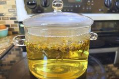 a glass jar filled with liquid sitting on top of a counter