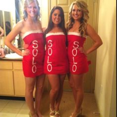 three beautiful women in red dresses standing next to each other