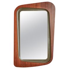 a mirror that is made out of wood and metal, with a green trim around the edge