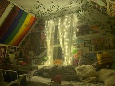 a bedroom with lights strung from the ceiling and curtains on the windowsill above it