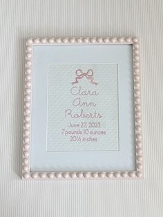 a white frame with a pink bow on it