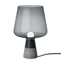 a gray table lamp with a white light on it's base and a black cord