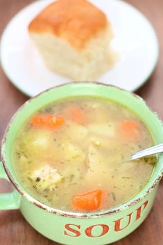 a bowl of soup and a piece of bread on a table