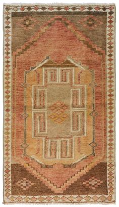 an orange and brown rug with geometric designs on the bottom, in front of a white background