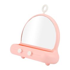 a pink vanity mirror sitting on top of a table