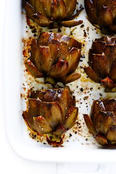 roasted artichokes in a white baking dish