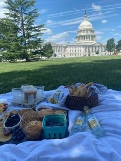 a picnic is set out in front of the capitol building with food and drinks on it