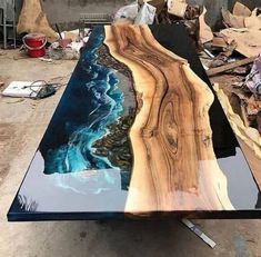 a table that is made out of wood and has blue paint on the top, while it