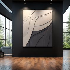 an abstract painting hangs on the wall in a room with wood floors and large windows