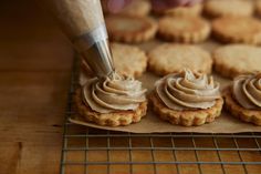 a person is decorating cookies with icing