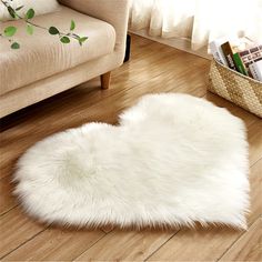 a white heart shaped rug on the floor