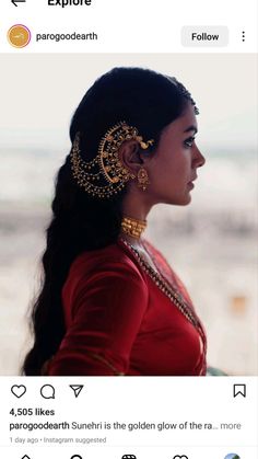 an image of a woman with long hair and gold jewelry on her head, looking off into the distance