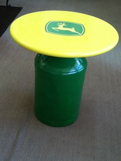 a green and yellow table sitting on top of a wooden floor