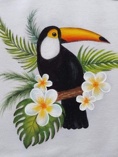 a painting of a toucan on a white shirt with flowers and palm leaves