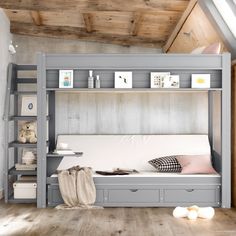 there is a bunk bed with two drawers and a mattress on the bottom shelf next to it