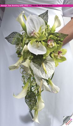 a bridal bouquet with white flowers and green leaves