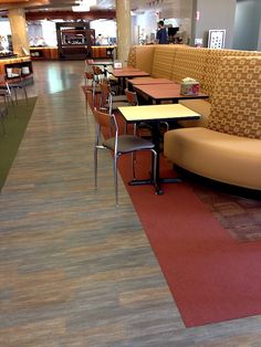 an empty restaurant with tables and chairs on the floor, but no one is in it