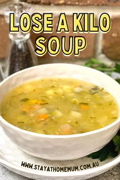 a white bowl filled with soup on top of a plate