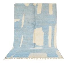 a blue and white rug with fringes on it