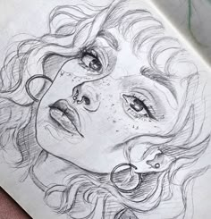 a pencil drawing of a woman's face with curly hair and glasses on it