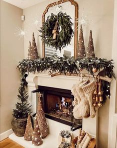 a fireplace decorated for christmas with stockings and garland