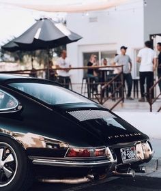 a black car parked in front of a restaurant