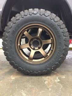 the wheel and tire of a truck parked in a parking lot