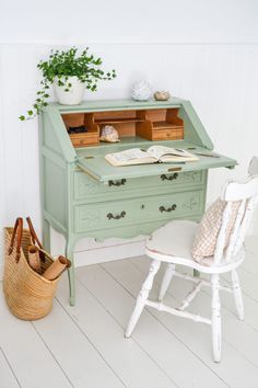 an old green desk and chair in a white room