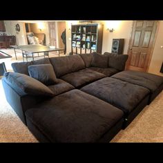 a large sectional couch in the middle of a living room