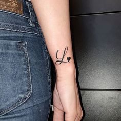 a woman with a small tattoo on her arm