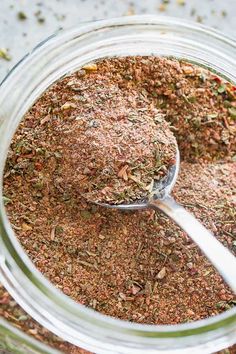 a jar filled with ground spices and a spoon