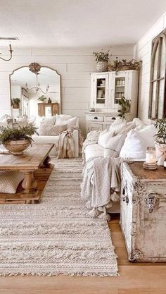 a living room filled with lots of furniture next to a white couch and coffee table