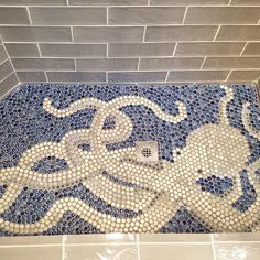 a bathroom with blue and white tiles on the floor