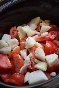 chopped tomatoes and onions in a slow cooker