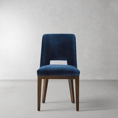 a blue chair sitting on top of a white floor