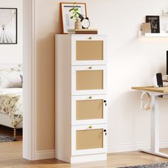 a white cabinet with four drawers and a clock on top, in a room next to a bed