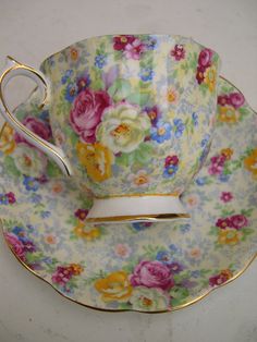 a tea cup and saucer with flowers on it