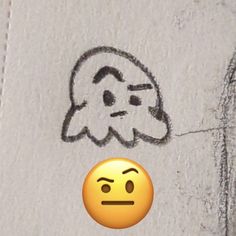 a smiley face drawn on the side of a wall next to a drawing of a man's head