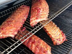 meat is being cooked on the grill with tongs