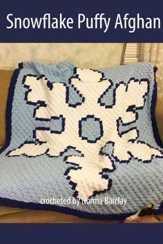 A cozy blue and white crocheted Snowflake Puffy Afghan draped on a beige sofa, featuring a large, bold snowflake design made using the C2C stitch. Snowflake Afghan, Puffy Crochet, Cozy Crochet Blanket, Corner To Corner Crochet Pattern, Crochet Pattern Written, C2c Crochet Pattern, C2c Graph, Crochet Bloggers, Corner Crochet