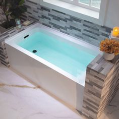 a bathroom with a large jacuzzi tub next to a window