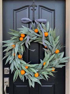 an orange wreath is hanging on the front door