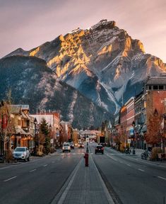 an empty street with mountains in the background