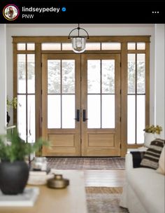 a living room filled with furniture and wooden doors